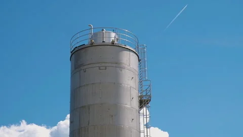 Lone silo tower on blue sky background. Storage of agriculturals or chemicals Stock Footage 261269097