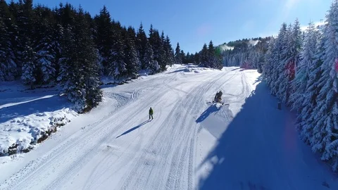 A lone skier going down an empty ski slope Stock Footage 86113379