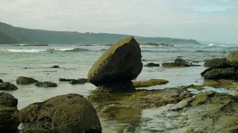 Lone standing rock on beach Stock Footage 274345313