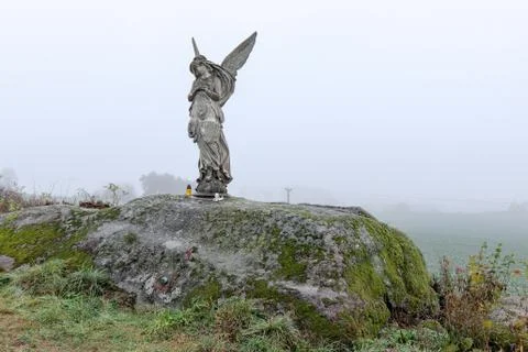 Lone statue of an angel in the fields Stock Photos