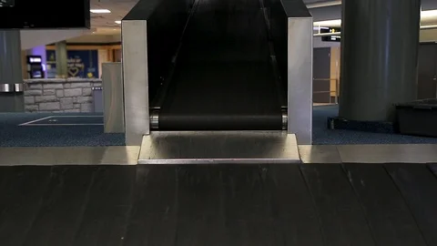 A lone suitcase on a baggage carousel with a biohazard sign fading in to denote Stock Footage 123882322