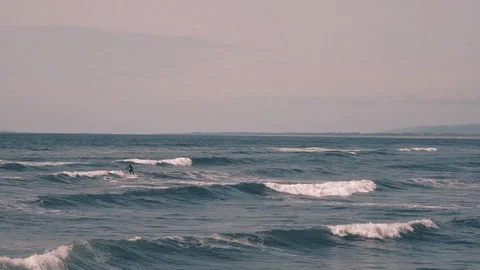 Lone surfer rides waves on the Oregon coast Video stock 109247556