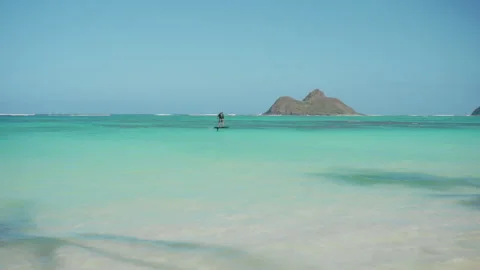 Lone Surfer surf on electrical board, having fun on Waves on a Pristine Tropical Stock Footage 274046825