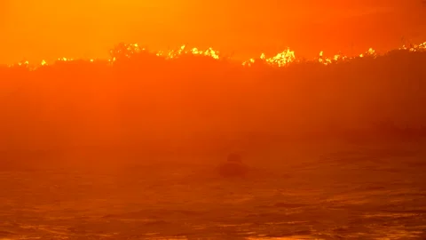 Lone swimmer diving under wave sunset real time Stock Footage 146875961