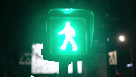 A lone traffic light changes from red to yellow to green in the downtown of a Stock Footage 256739162