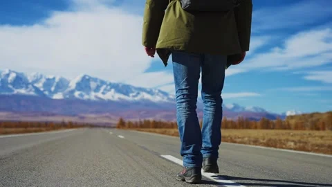 Lone traveler strides down a vast highway Stock Footage 342736213