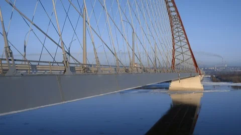 Lone urban Runner Jogging across Industrial Transport Bridge above winter river. Stock Footage 102461214
