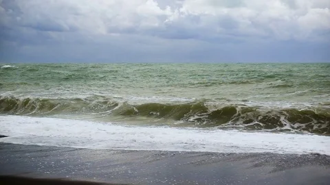 A lone wave twists on a black shore slow mo Stock Footage 82168841