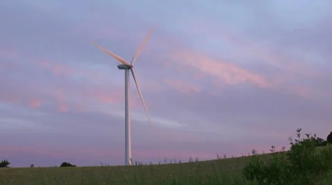Lone Wind Turbine at Sunset - Loops Stock Footage 7745898