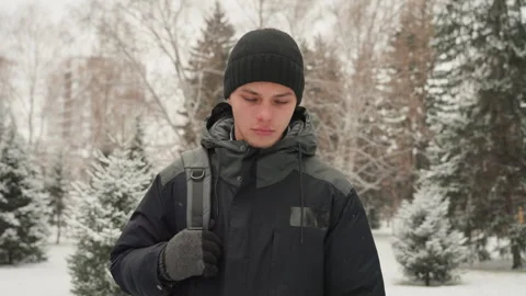 Lone winter figure. Isolated man amidst frozen snow. Solitary individual stands Stock Footage 338433708