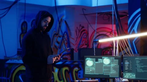 Lone wolf hacker in hideout trying to avoid being detected, using tablet Stock Footage 319518949