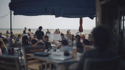 Lone woman at a restaurant in Venice beach, Los Angeles Stock Footage