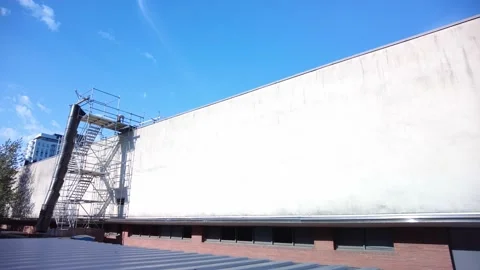 Lone Worker Throws Garbage Down Roof Chute  Stock Footage 204057554