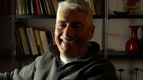 Lonely and relaxed mid aged man smiling in camera: home portrait Video stock 74425281