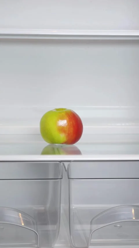 A lonely apple in an empty refrigerator Stock-Footage 323431798