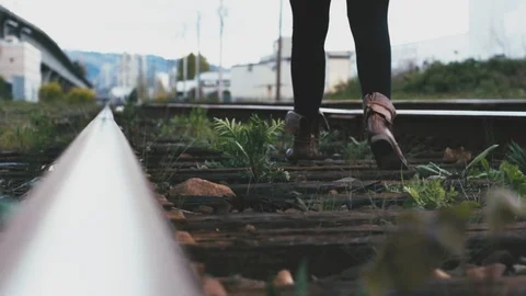 Lonely Backpacker walks to the Horizon on a Train Track Stock Footage 94595499