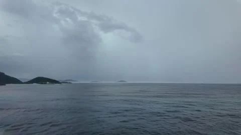 Lonely Beach and Ocean Under Heavy Clouds Stock Footage 296428080