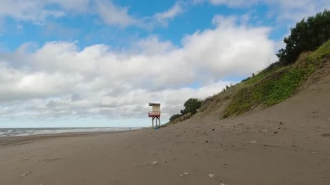 Lonely beach, lifeguard box, soft waves and blue sky with white clouds movi.. Stock Footage 272276112