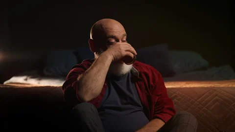 Lonely bearded man drinks liquor at home, struggling with midlife crisis Stock Footage 346714210
