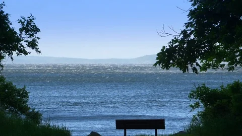 Lonely Bench in Alone Park, Open Ocean Slow Motion Sea Water and Sky Stock Footage 84332030