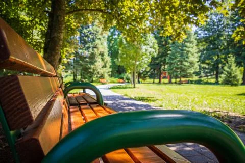 A lonely bench in an empty park Stock Photos