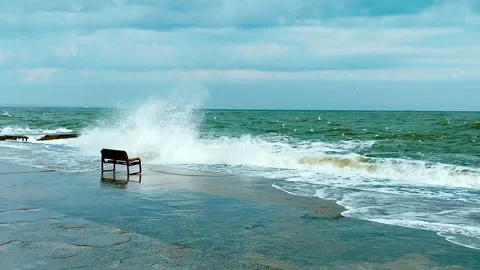 Lonely bench. It is standing on the seashore. Storm. Stock Footage 269061363