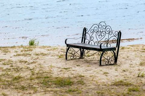 Lonely bench by the lake. Stock Photos