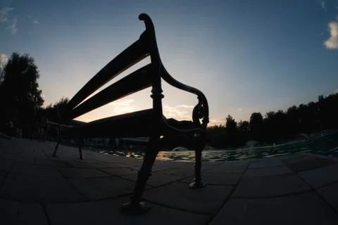 Lonely bench at sunset Stock Photos