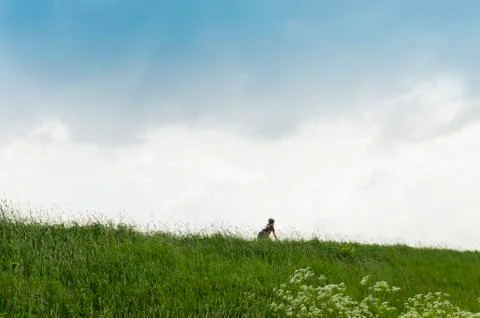 Lonely biker on dike Stock Photos