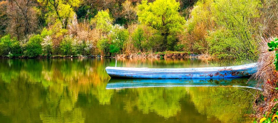 Lonely boat on spring lake. Stock Photos