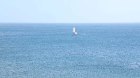 Lonely boat whitening against amazing background of endless blue sea surface Stock Footage