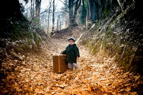 Lonely boy with suitcase Stock Photos