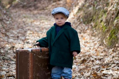 Lonely boy with suitcase Stock Photos
