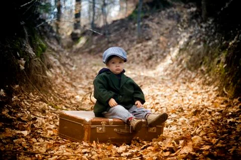 Lonely boy with suitcase Stock Photos