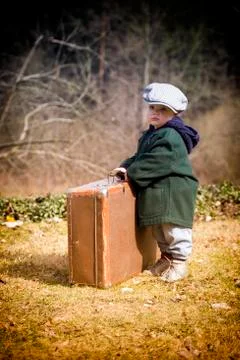 Lonely boy with suitcase Stock Photos