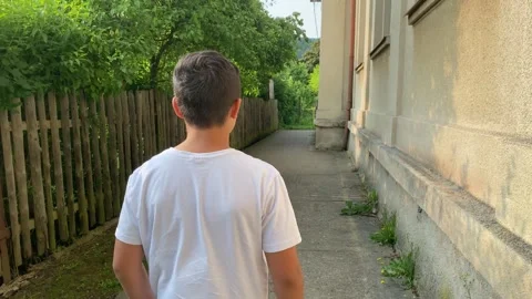 Lonely Boy Walking on Sidewalk Sad Mood, Urban Scene Stock Footage 311009964