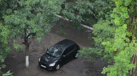 Lonely car stands under rain in the yard Stock Footage 25856740