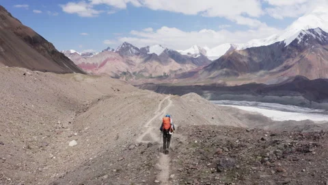 Lonely Climber in mountaineering Gear, backpack and trekking poles during Lenin Stock-Footage 314088043