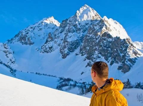 A lonely climber reaching the summit Stock Photos