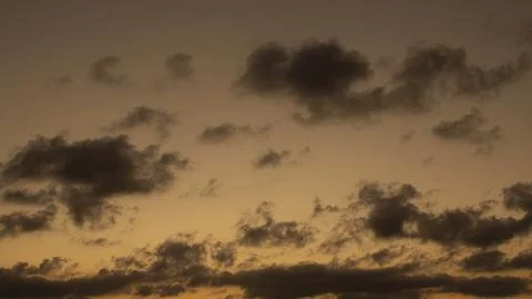 Lonely clouds in a sunset Stock Photos
