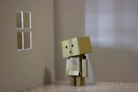 Lonely Danbo in front of the window Stock Photos