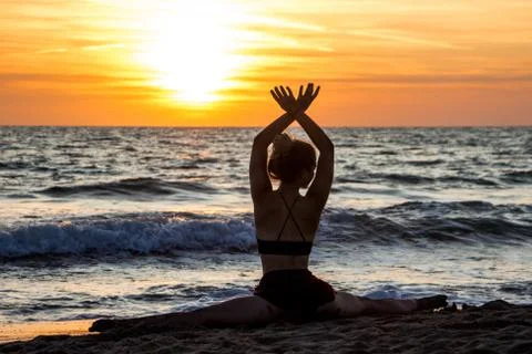 Lonely Dancer ballet posing on the beach sunset silhouette sea Stock Photos