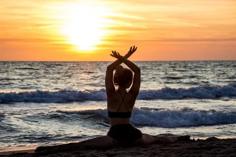 Lonely Dancer ballet posing on the beach sunset silhouette sea Stock Photos