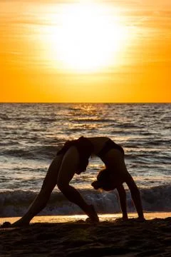 Lonely Dancer ballet posing on the beach sunset silhouette sea Stock Photos