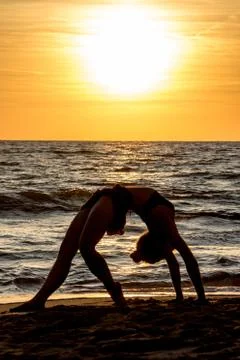 Lonely Dancer ballet posing on the beach sunset silhouette sea Stock Photos