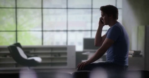 Lonely depressed man calling his best friend Stock Footage 78599863