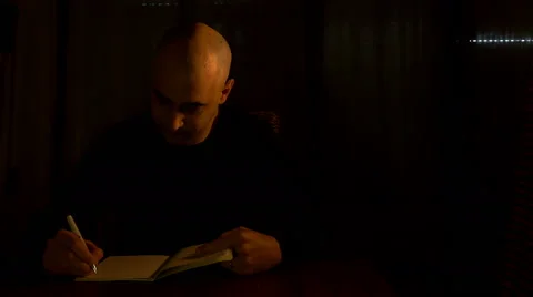 Lonely director takes writing notes on his notebook Stock Footage 61765697