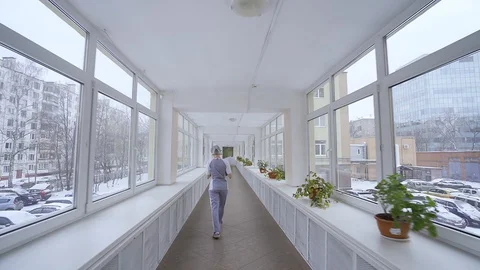 Lonely doctor walks down corridor in Russian hospital where there are not enough Stock Footage 127596760