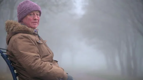 Lonely Elderly Man Sits Alone in Park Medium Shot Stock Footage 147892689