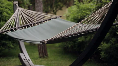 Lonely empty hammock stretched between trees in the woods or in the Park. The Stock Footage 100892363